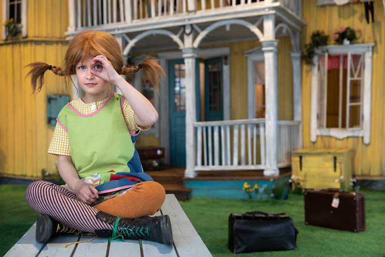 Pippi Longstocking sitting outside her house Villa Villekulla at Junibacken. Stockholm for kids.