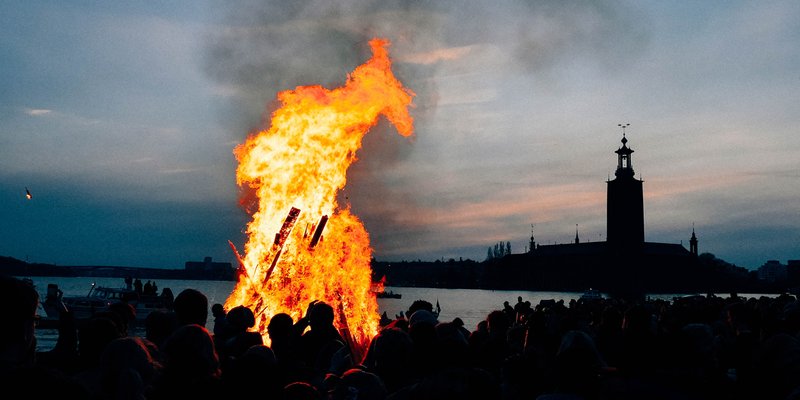 A traditional Walpurgis bonfire on Riddarholmen in Stockholm. The Stockholm City Hall is visible in the background. Walpurgis, or Valborgsmässoafton, is a Swedish tradition that dates back to the Middle Ages. It&#x27;s celebrated the 30th of April each year.