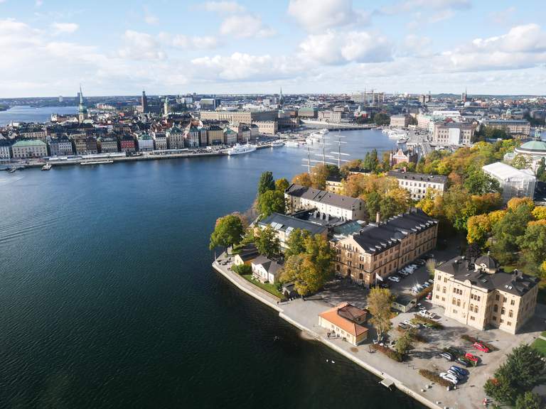 An aerial photo of Stockholm and it's inner city islands, in the fall season as the trees are turning yellow and orange