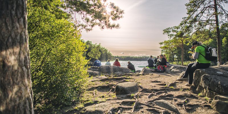 People resting their feet at Domarudden on the hiking path Roslagsleden.