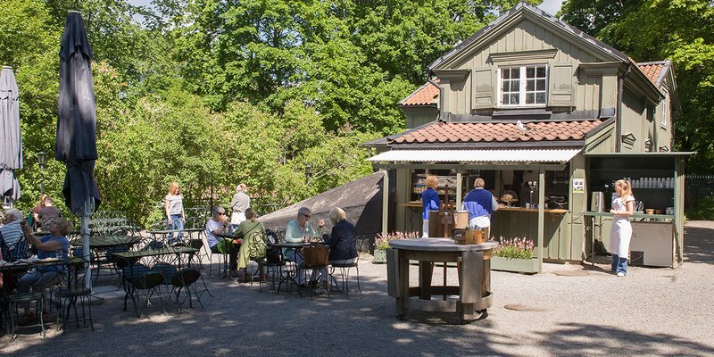 Fika in Stockholm. Café Ektorpet, exterior. A sunny summers day at Café Ektorpet. The scenery has a lovley green color at Waldemar Udde´s museum café.