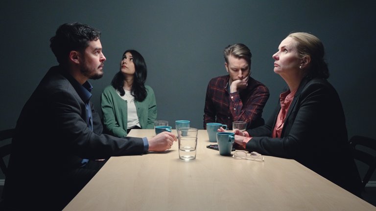 four people sitting at a table