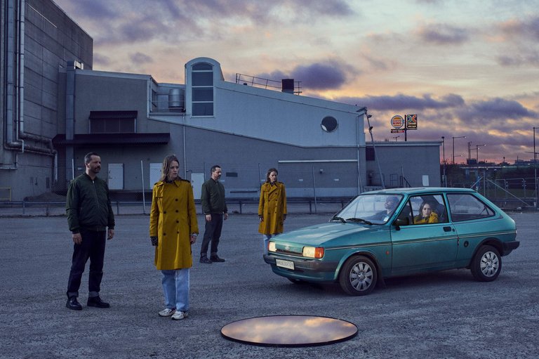 people standing near and sitting in a car