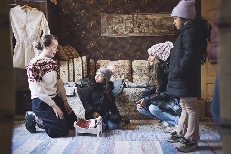 two adults and two children in the Ironmonger’s apartment in Skansen