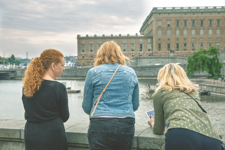 three people in front of the Royal Palace