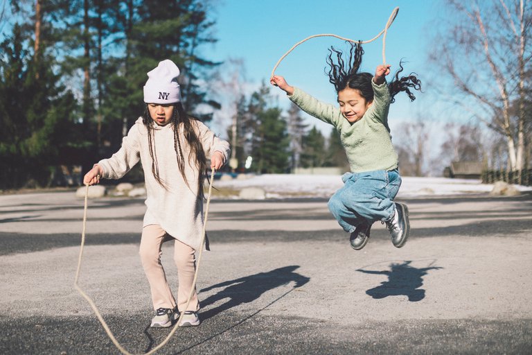 Two children jumping rope.