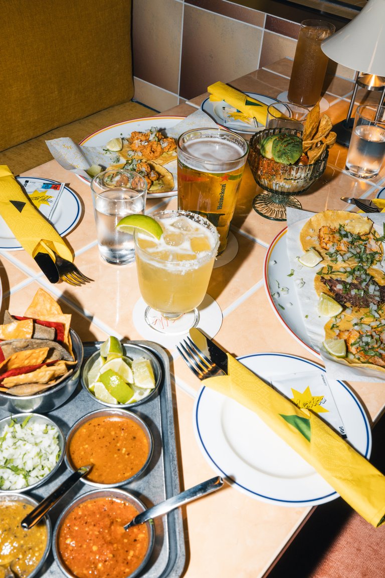 Several plates with various taco dishes.