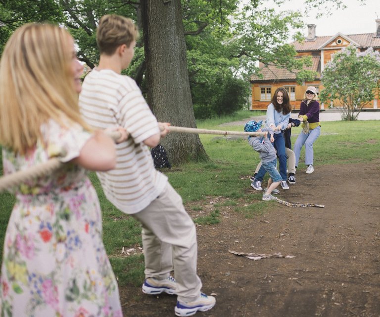 children and adults play outdoor games