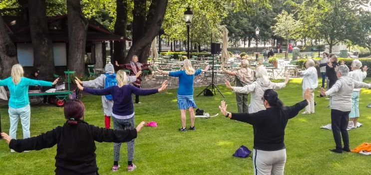 People practicing Qi Gong in a park.