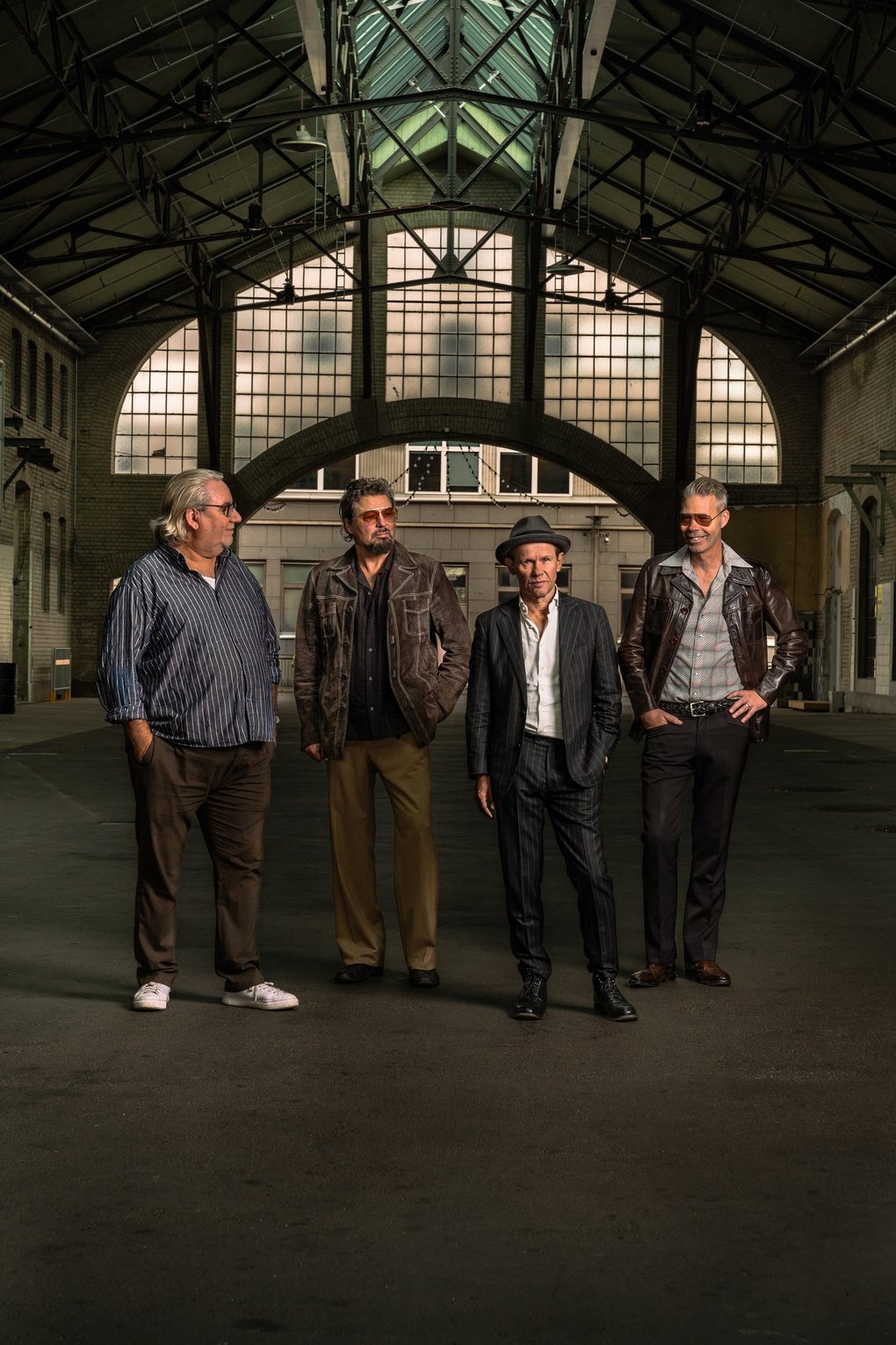 The four members of Bo Kaspers Orkester standing in a warehouse.