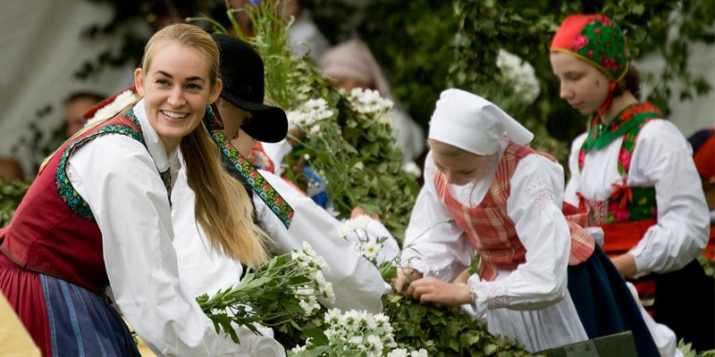 Teenagers dressed in colorful old traditional Swedish costumes, during Midsummer celebrations at the Skansen open-air museum in Stockholm. Midsummer is celebrated at the longest day of the year—when the sky never darkens. It’s one of the most characteris