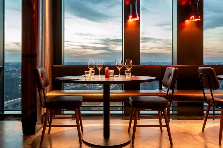 A set table by a window with a view.