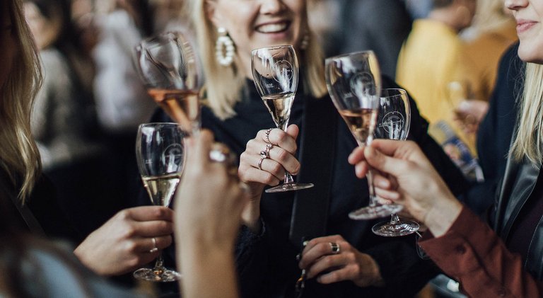 People holding champagne glasses.