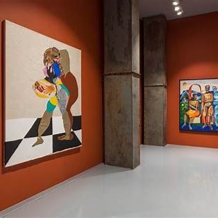 A gallery room with large colorful figurative paintings on deep orange walls, one painting shows a single figure holding something. A second painting in the background includes multiple figures in vivid, expressive colors.